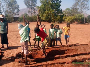 Digging a hole to plant a moringa seedling in a school in Madagascar