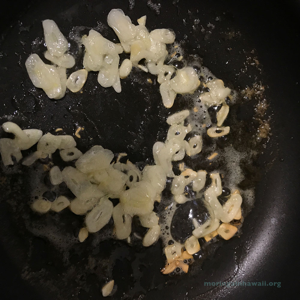 Finely sliced garlic frying in butter
